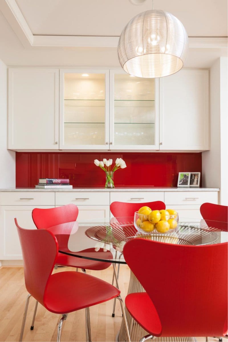 bright interior of a white kitchen with a touch of green