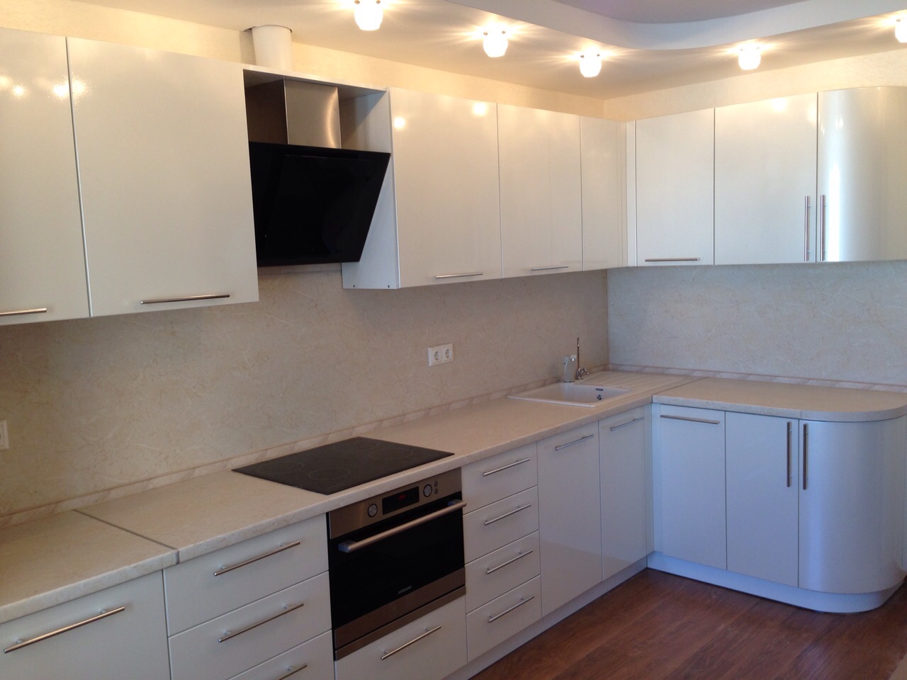 bright interior of a white kitchen with a touch of sand