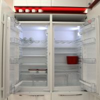 large refrigerator in the interior of the kitchen in a light color picture