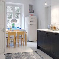 small refrigerator in the interior of the kitchen in dark color picture