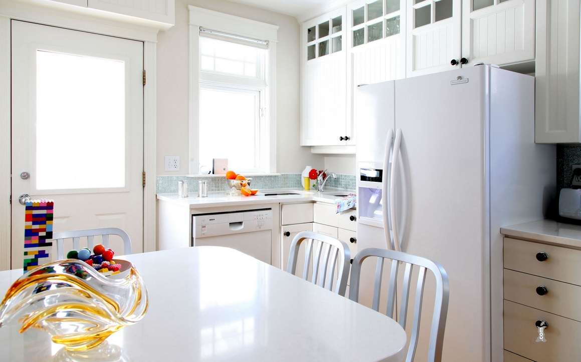 small refrigerator in the facade of the kitchen in steel color