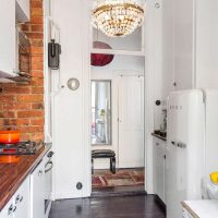 small refrigerator in the design of the kitchen in light color photo