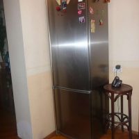 a small refrigerator in the facade of the kitchen in multi-colored color picture