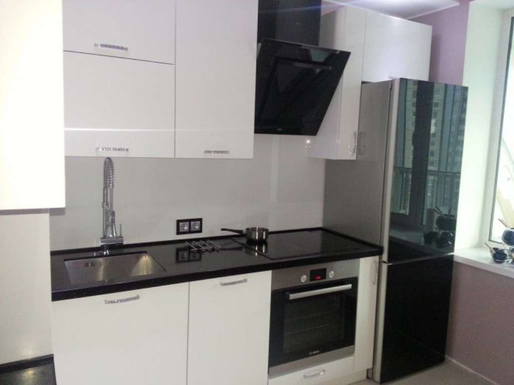 a small refrigerator in the decor of the kitchen in beige color