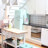 large refrigerator in the interior of the kitchen in bright color photo