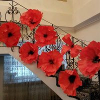 red paper flowers in the facade of the hall photo