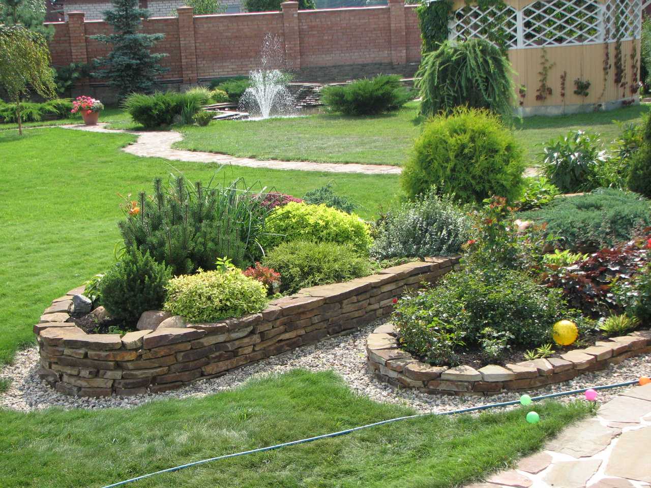 non-standard creation of design of a summer cottage site with stones with your own hands