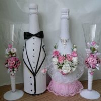 bright decoration of champagne bottles with colorful ribbons photo