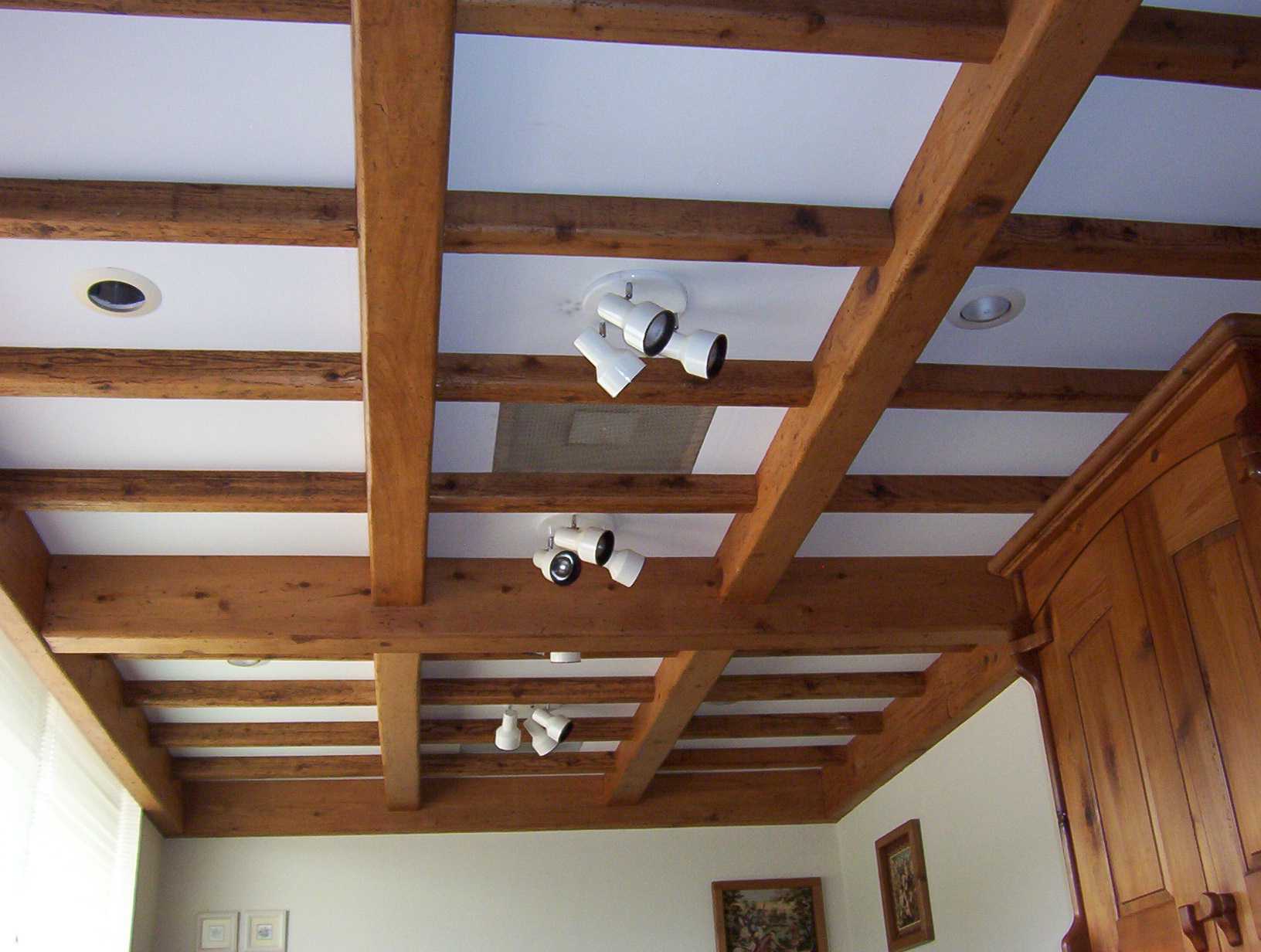 the idea of ​​a bright living room interior with decorative beams