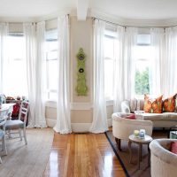 example of an unusual design of a living room with a bay window photo