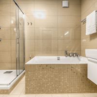 An example of a light bathroom interior in beige color photo