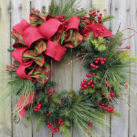 Christmas wreath of branches of berries and ribbons