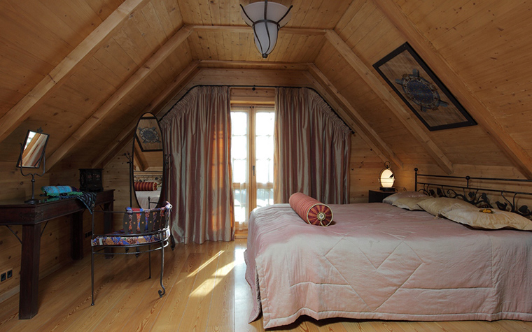 bedroom in a wooden house in the attic