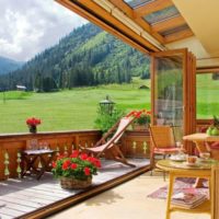 Sliding windows in the interior of the cottage veranda