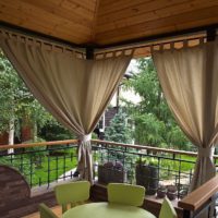 Curtains in the interior of the summer terrace