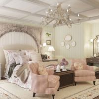 Chandelier with candles on the ceiling of the bedroom of a country house