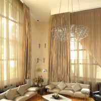 Long curtains in the living room with high ceilings