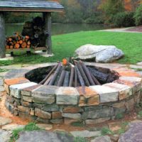 A fireplace made of stone in his garden