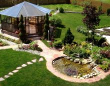 Garden furniture and homemade pond in the garden