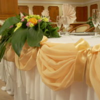 Beige tulle and lilies of the valley in the design of the wedding table