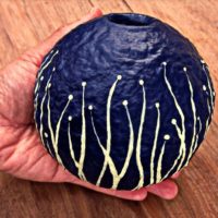 Papier mache vase in decorator's hand