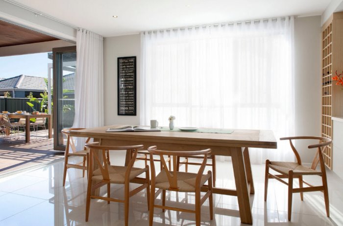 Transparent curtains on the grommets in the living room with a large window