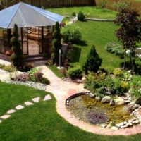 Polycarbonate gazebo in the garden landscape