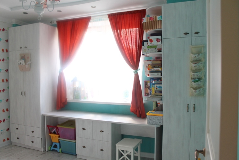 Table by the window in the interior of a children's room