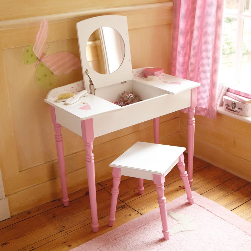 Little table with a mirror in the design of the children's room of the girl