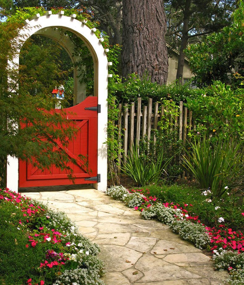 Flowers along the garden path leading to the gate of the summer cottage