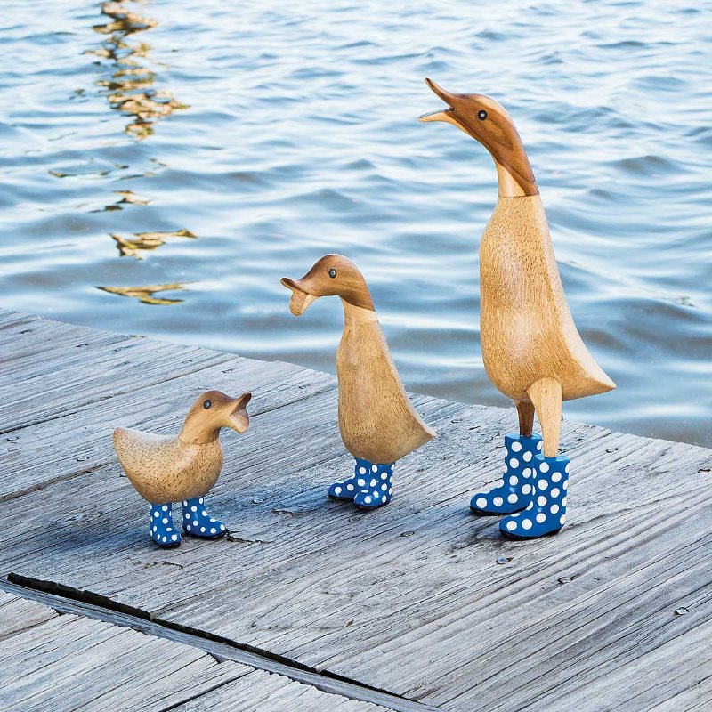 Decorative wood ducks on the shore of a summer cottage