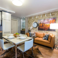 Brick wall over the sofa in the kitchen-living room