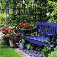 Blue bench behind a wooden pergola