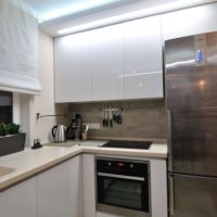 Glossy facades of a kitchen set in a studio apartment