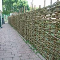 Wattle fence border of the summer cottage