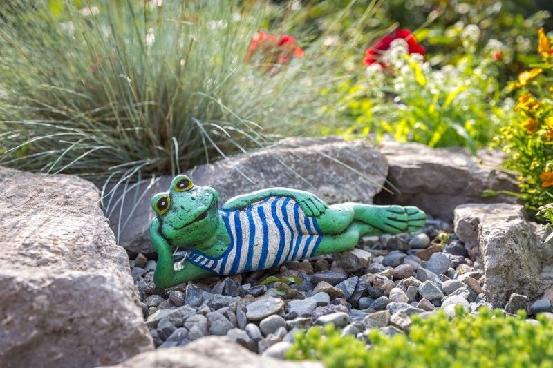 Cartoon frog figurine in garden decor