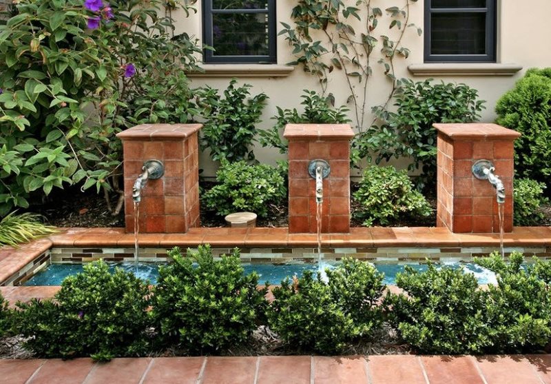 The original fountain in front of the wall of a country house