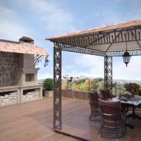 Metal gazebo on the roof of a country house