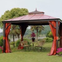 Wooden arbor on the lawn of a country house