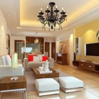 Black chandelier with candles on the living room ceiling