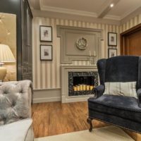 Black velvet armchair in the interior of a neoclassical room