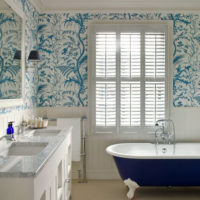 White tile and lilac ornaments on the bathroom wall.