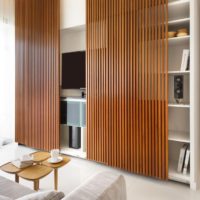 Sliding doors made of wooden slats on niche shelves