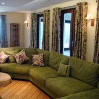 Upholstered furniture with olive-colored fabric upholstery in the room interior