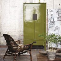 Retro chest of drawers olive color in the interior of the room