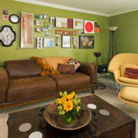 Brown furniture and olive walls in a spacious living room