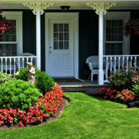 Rustic porch and green lawn.