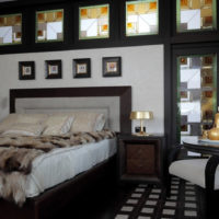 The contrast of white in the background of the black bedroom interior