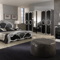 Glossy facades of wardrobes in a classic bedroom