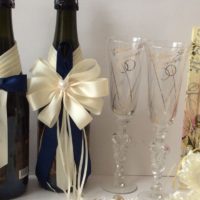 Cream satin ribbon bow on champagne bottle